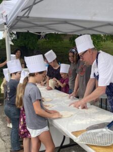 John Gutekanst, showing kids how to make pizza