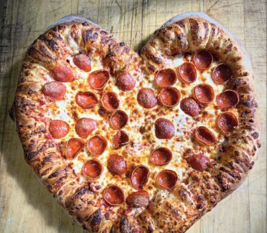 large pizzas in the shape of a heart.