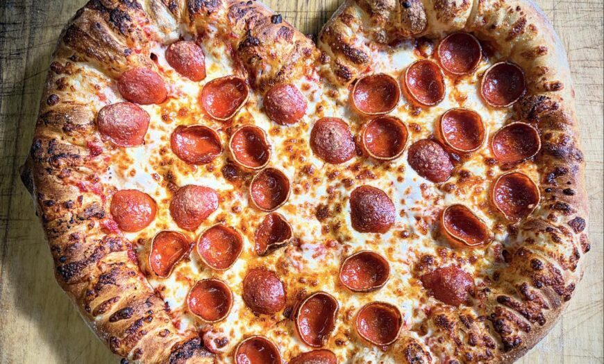 large pizzas in the shape of a heart.